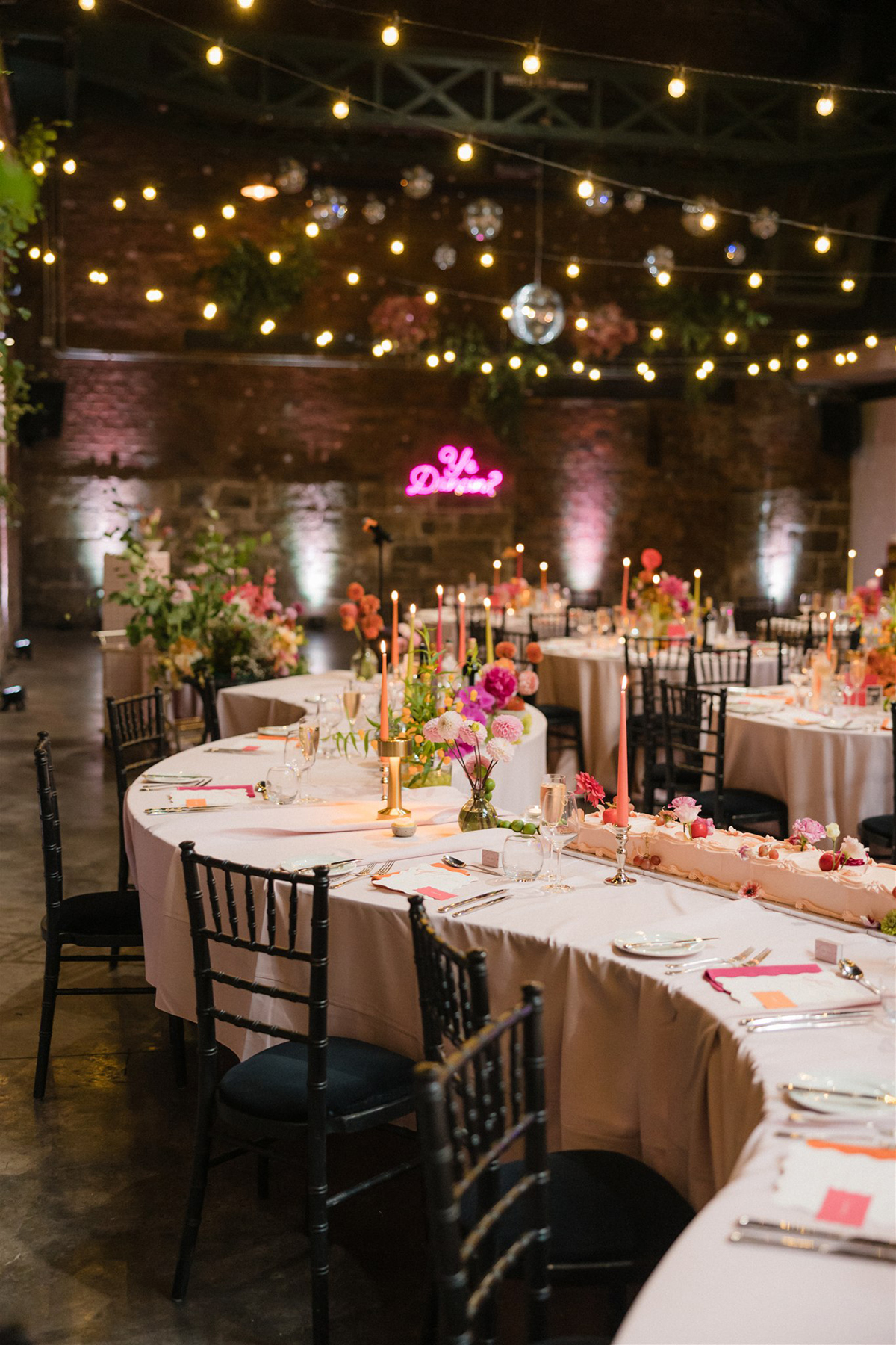 Colourful wedding reception tables with candles, flowers and disco balls at The Engine Works Glasgow