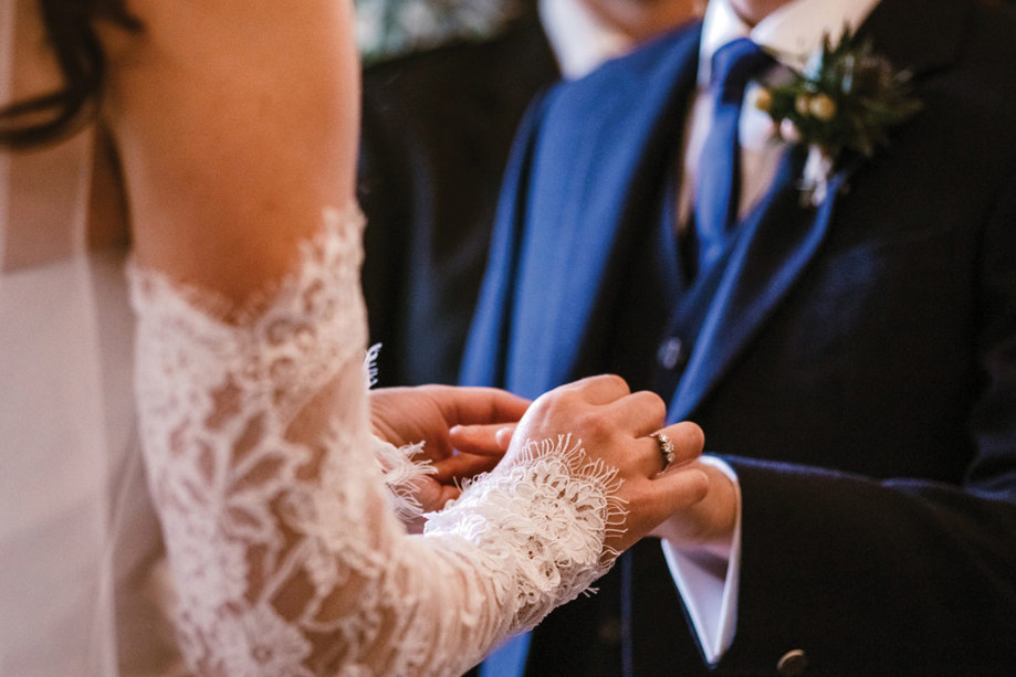 A Close Up Of Hands Of Bride And Groom Exchanging Wedding Rings