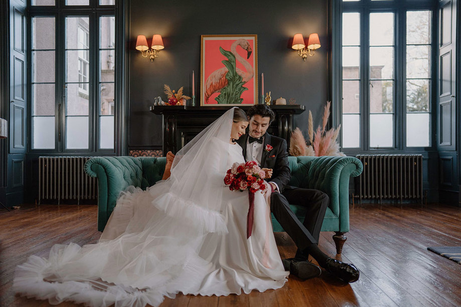 bride and groom sitting on a sofa