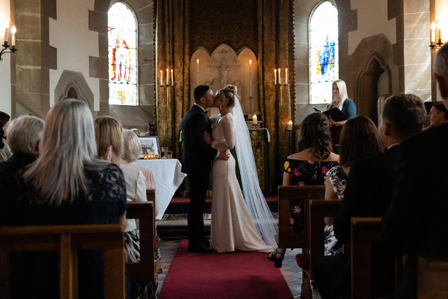 Bride and groom kiss at the end of their ceremony