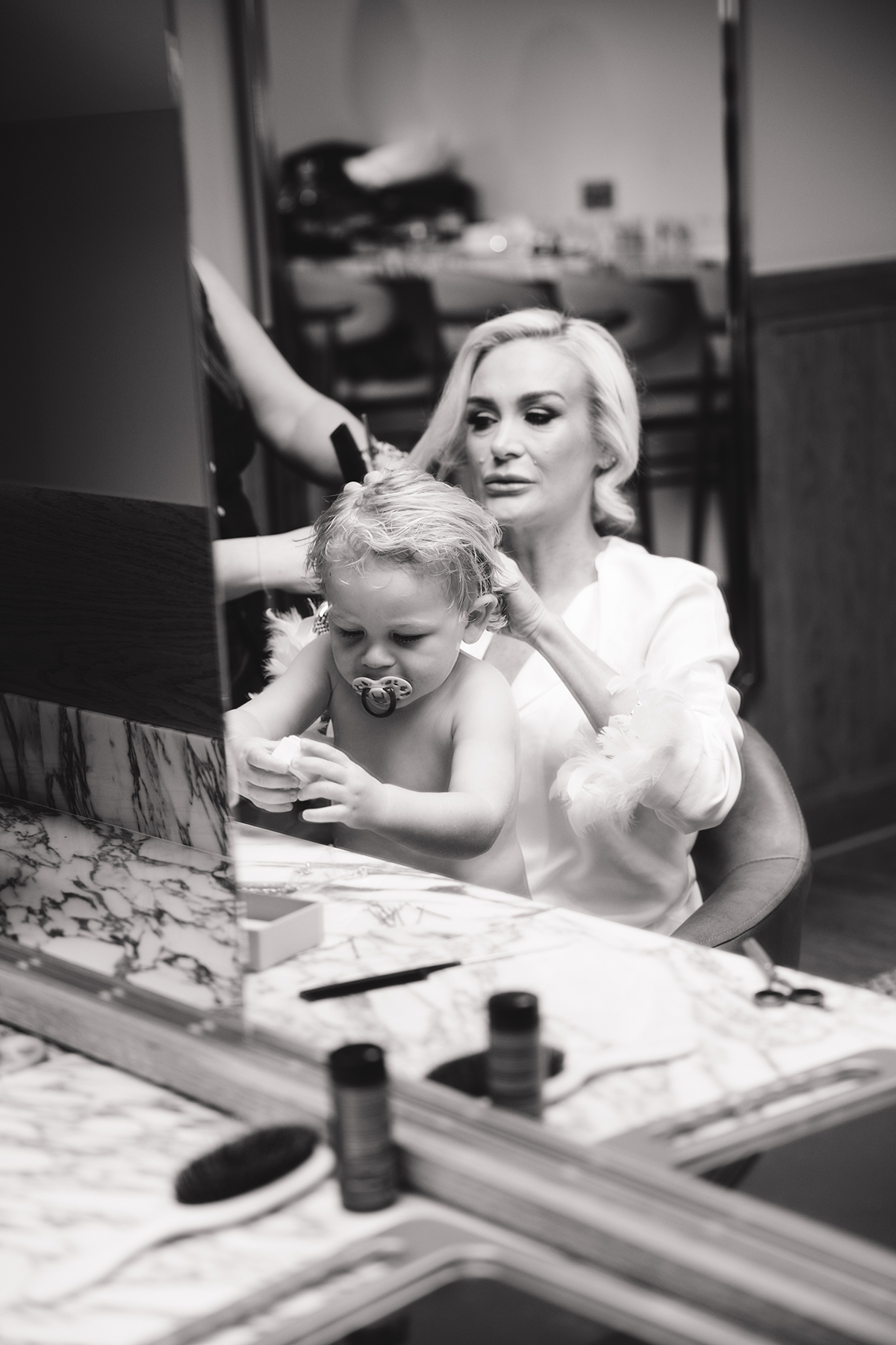 Bride getting ready with a young child during wedding morning preparations