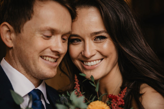 A Close Up Of A Smiling Bride And Groom