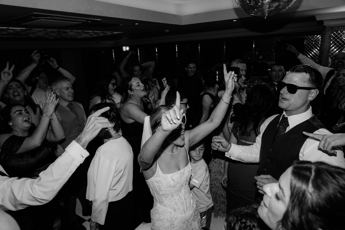 Guests dancing during lively Brisbane House Hotel wedding evening celebration