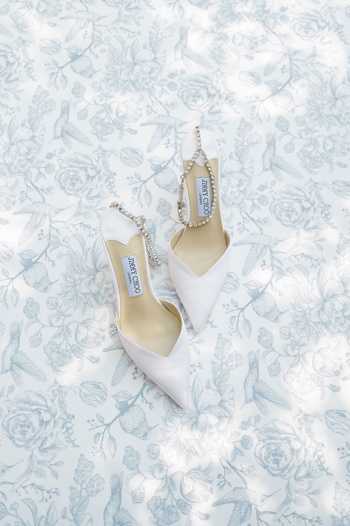 White Jimmy Choo bridal shoes photographed during Lake Como wedding preparations.