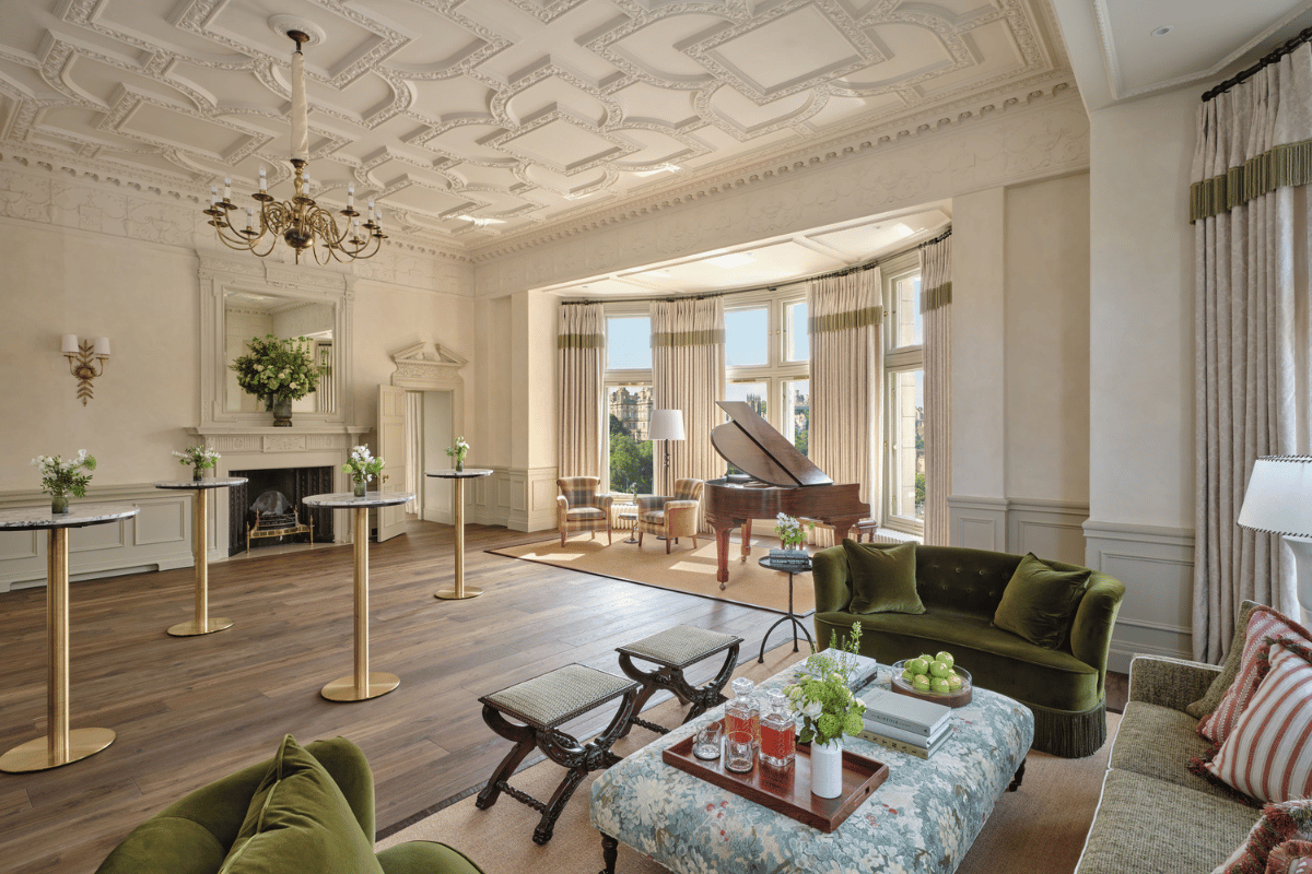 Elegant private event room at The Balmoral Edinburgh with a grand piano, fireplace, period ceiling and green velvet seating
