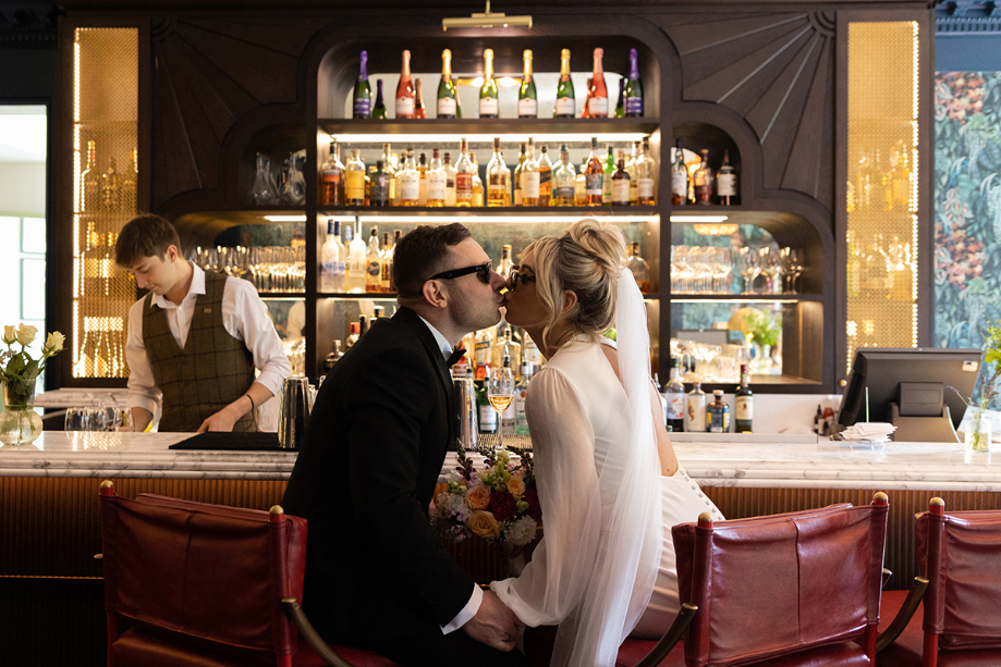 Bride And Groom Kissing At Bar