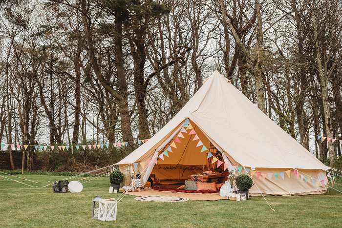 Teepee with colourful bunting pitched outside