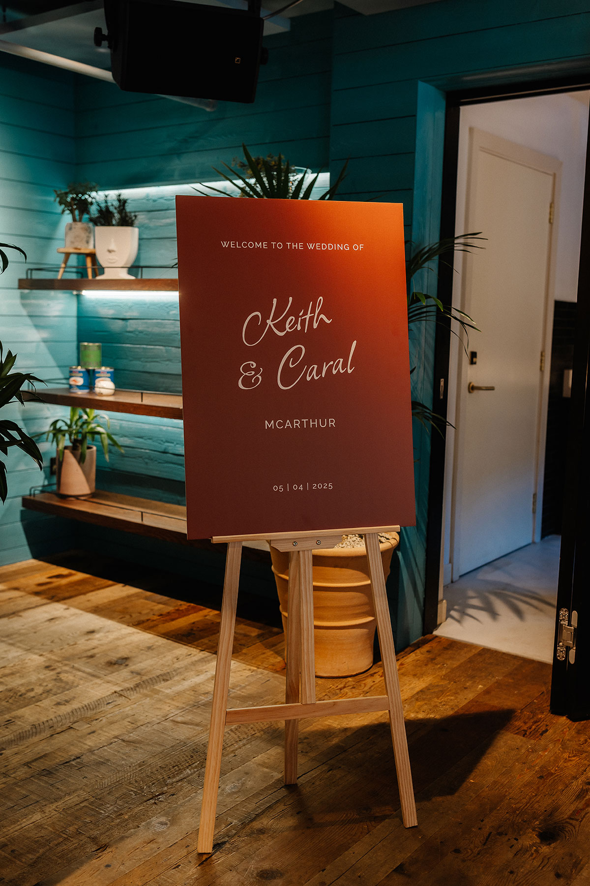 Rust-toned wedding welcome sign reading “Welcome to the wedding of Keith & Caral McArthur” displayed on an easel at Virgin Hotels Edinburgh.