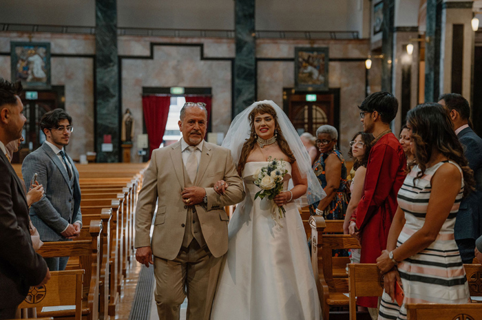 Bride and her father walking down aisle of St Aloysius Church