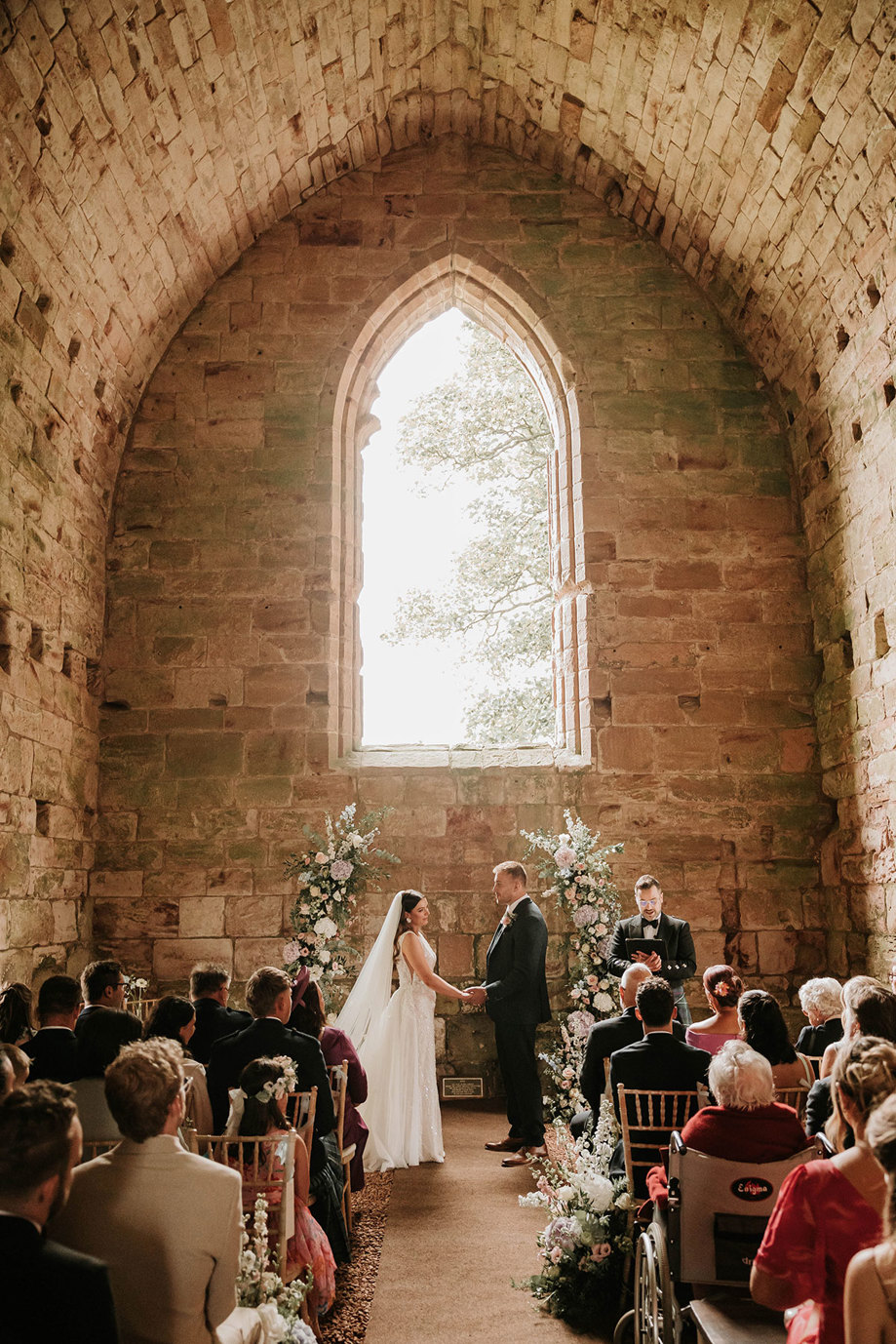 a wedding ceremony of a bride and groom Matt Fagerson in ruined church setting at Dunglass Collegiate Church