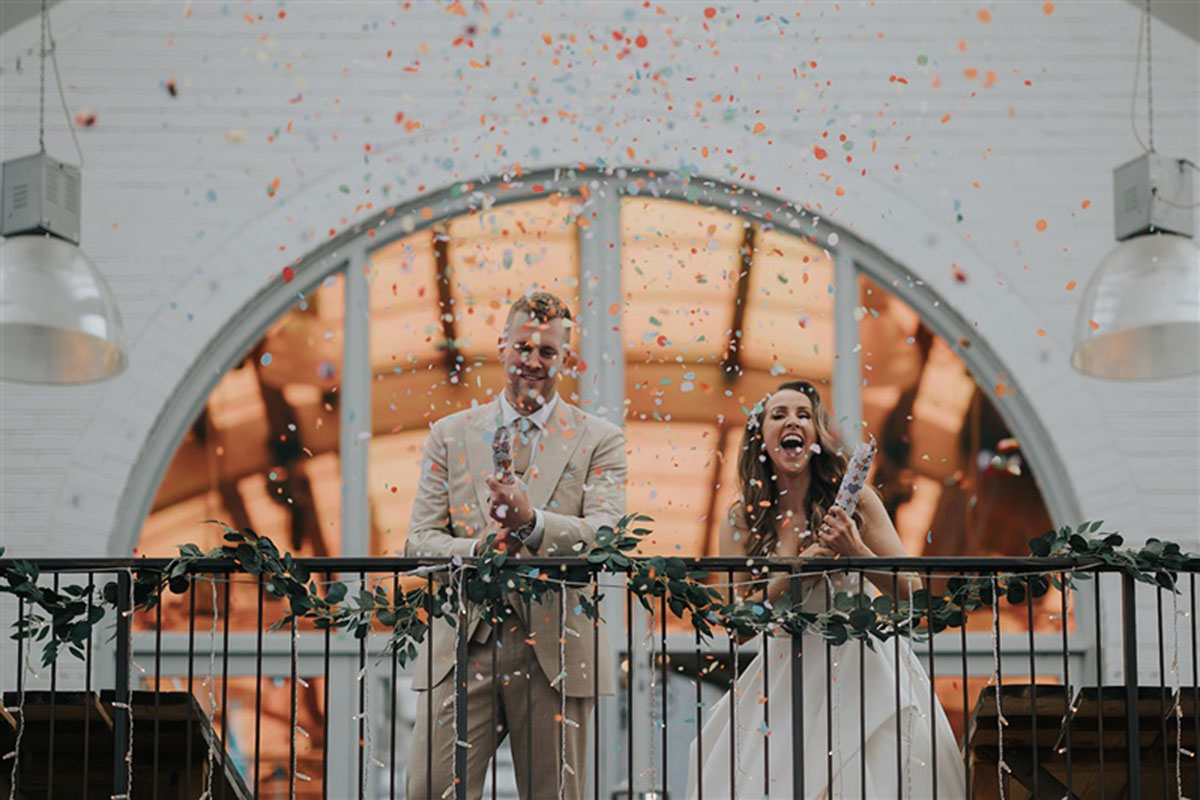 Couple using confetti cannons