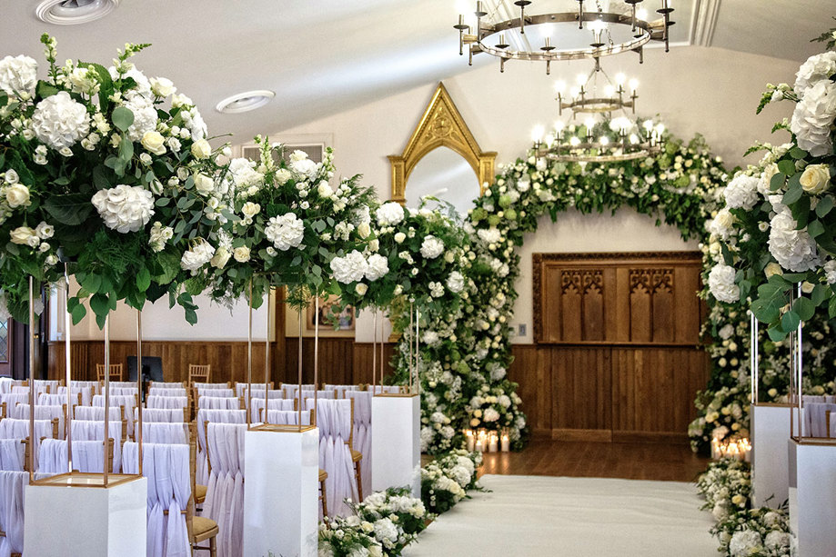 James Little Hall at Crossbasket Castle decorated for a wedding with abundant white flowers and green foliage