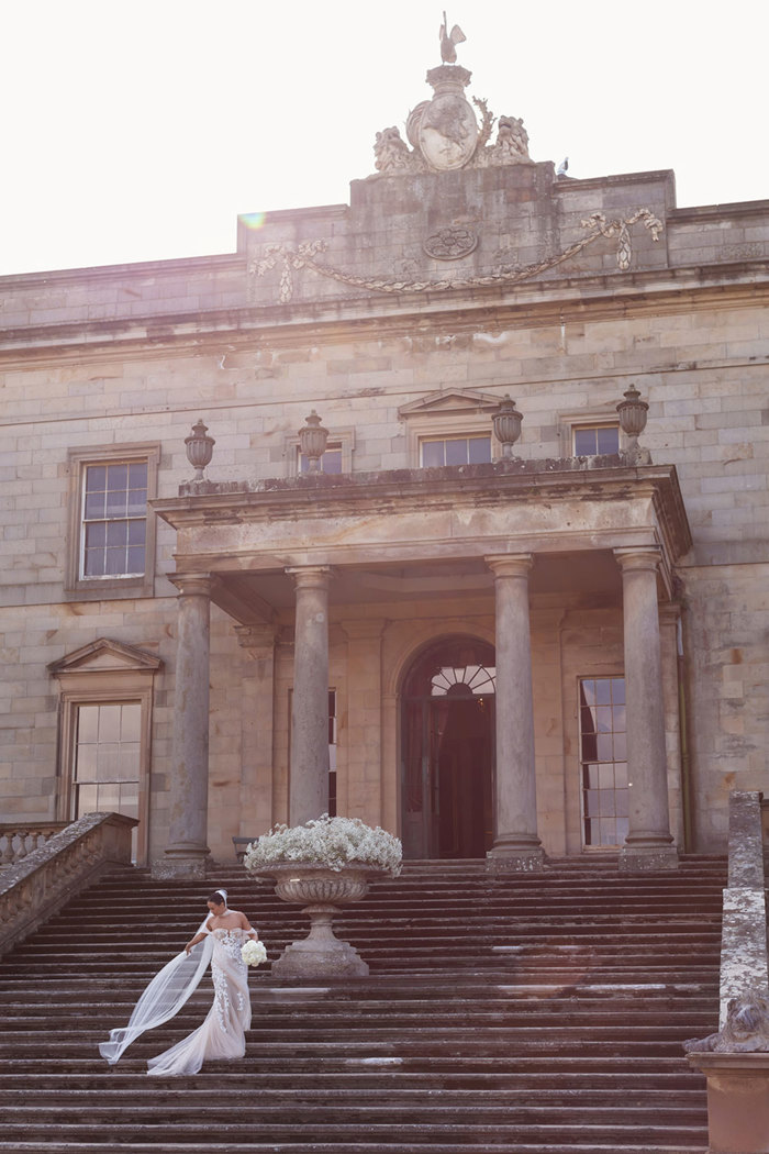 a bride in an Opus Couture wedding dress on an exterior staircase at Gosford House.