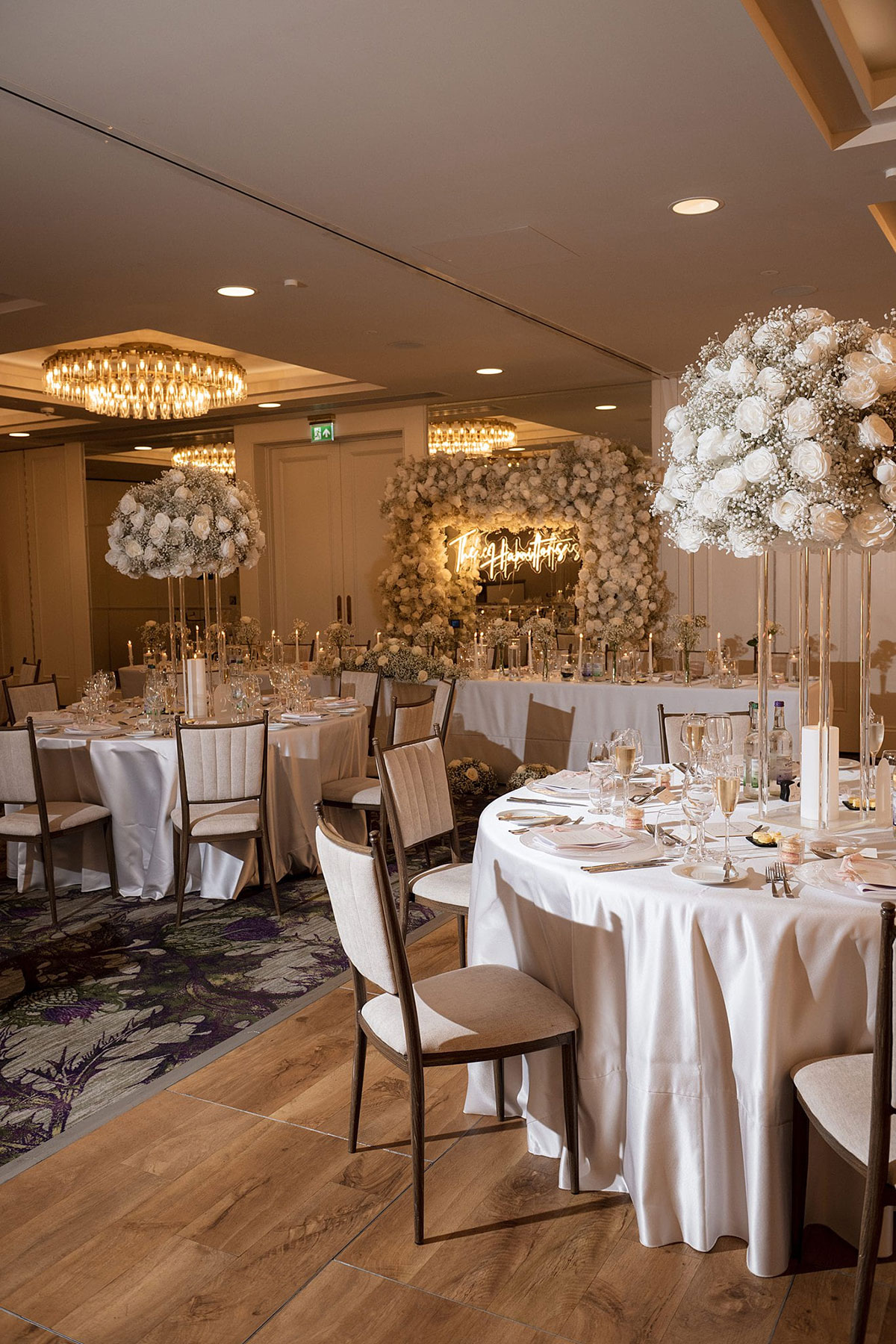 Elegant wedding reception set-up with tall white rose and gypsophila centrepieces at Old Course Hotel St Andrews wedding reception.