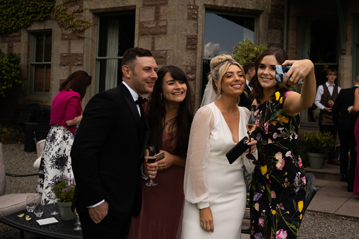Bride and groom take Selfies With Guests