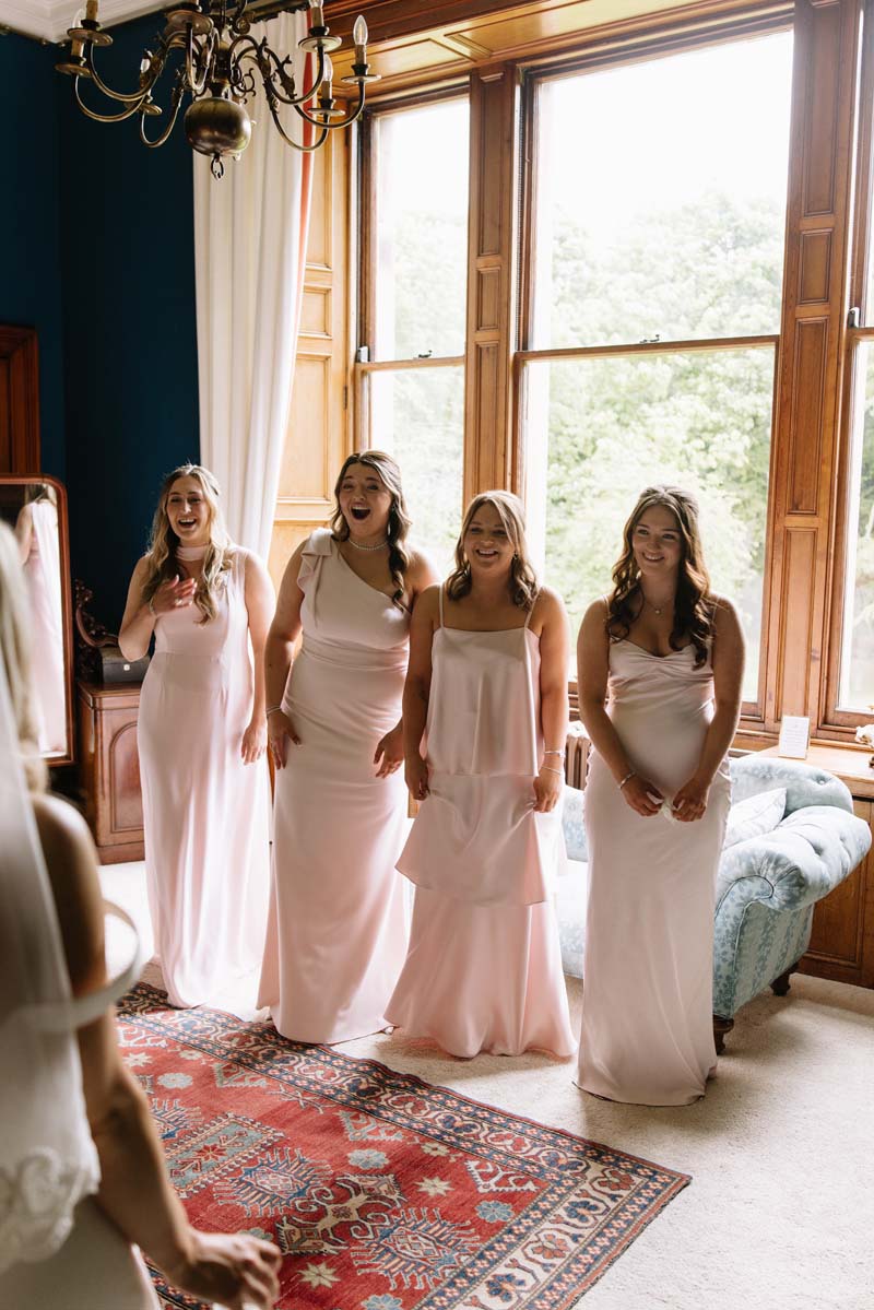 Lia’s bridesmaids react during their first look at the bride before the Cambo House wedding ceremony.