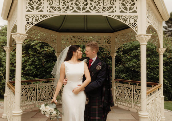 bride and groom stand in pavillion at kilmardinny house in bearsden