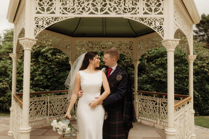 bride and groom stand in pavillion at kilmardinny house in bearsden