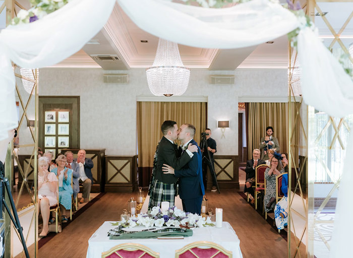 grooms kissing during wedding ceremony at Boclair House