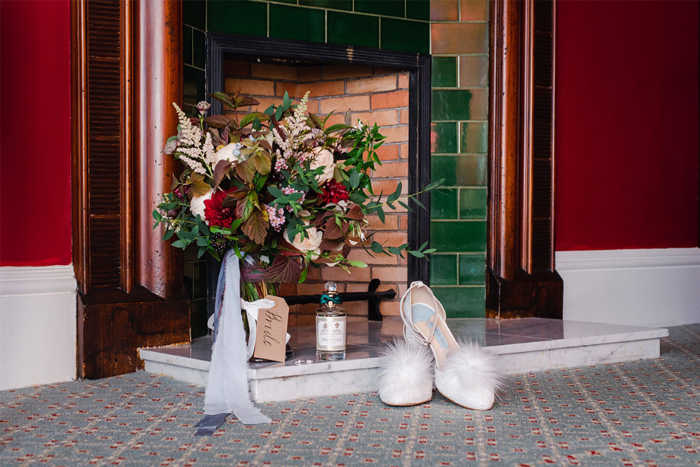 Detail shot showing bride's bouquet, shoes and perfume