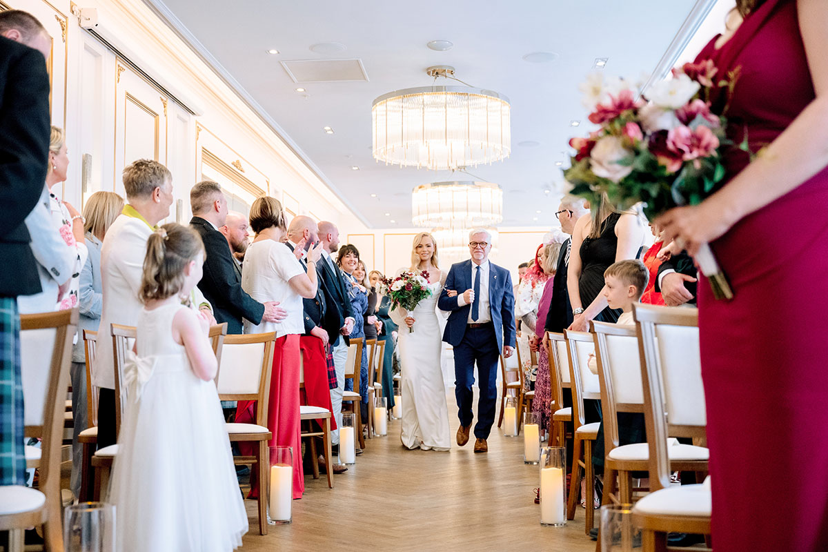 Bride walking down the aisle with father at The Exchange Glasgow wedding.