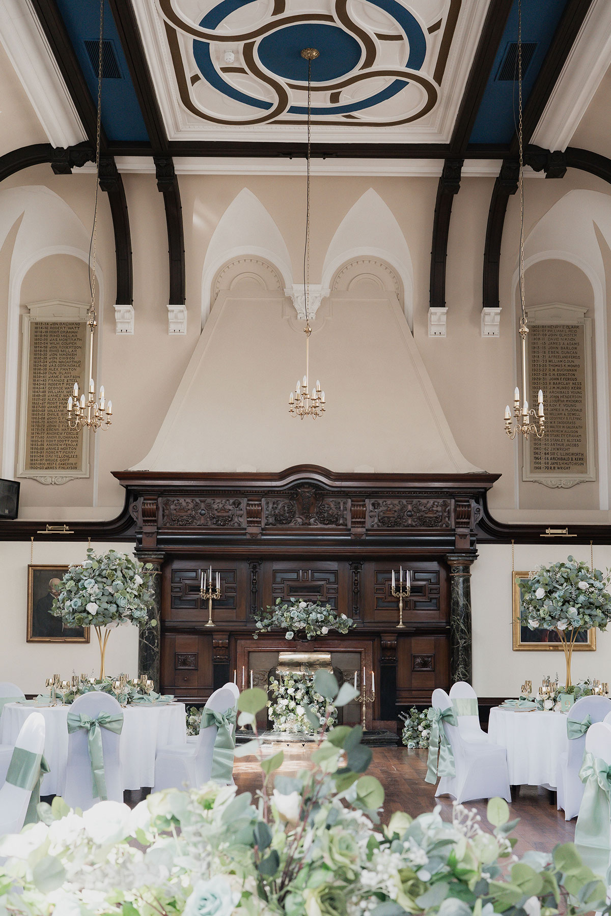 round tables with white table cloths and green flowers set up for wedding dinner at 1599 glasgow