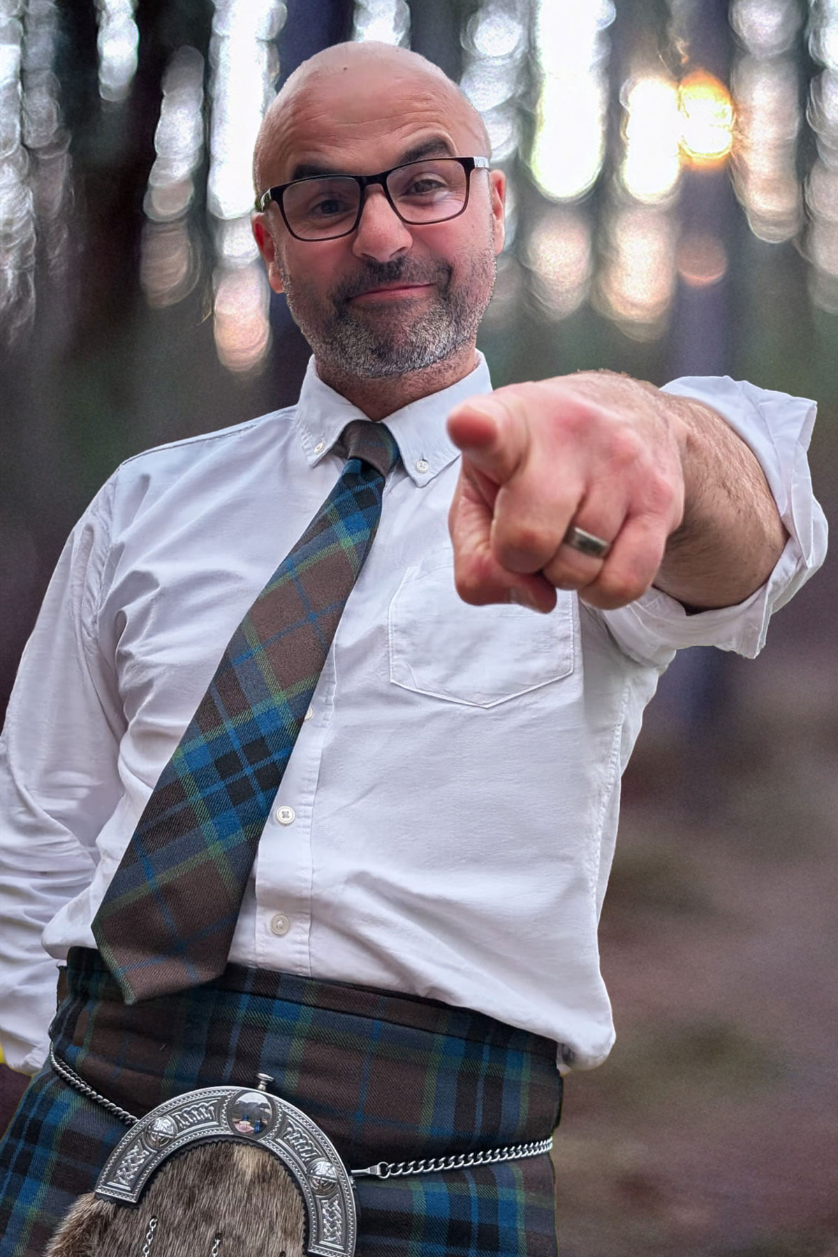 Celebrant David Cranna in kilt pointing at camera