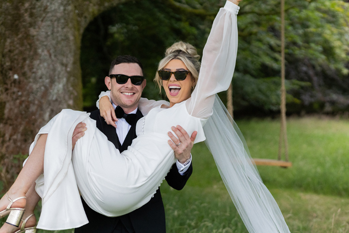 Bride And Groom Wearing Sunglasses By A Tree