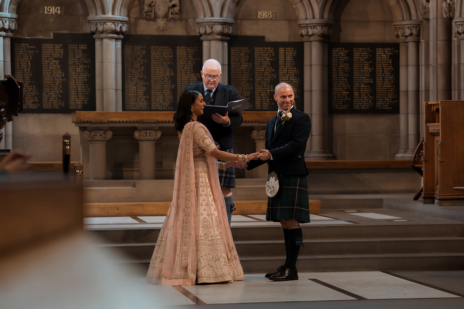 A Wedding Ceremony of a bride and groom At Glasgow University Memorial Chapel