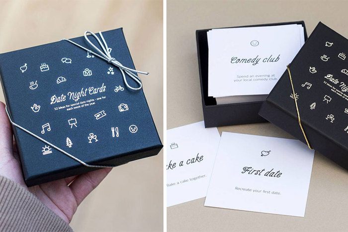 A square blue box full of white cards with date ideas
