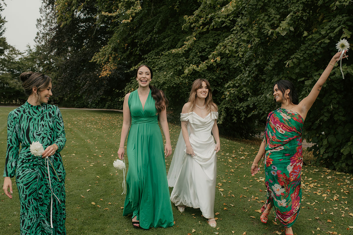 a bride and bridesmaids walking in grounds of Achnagairn Castle