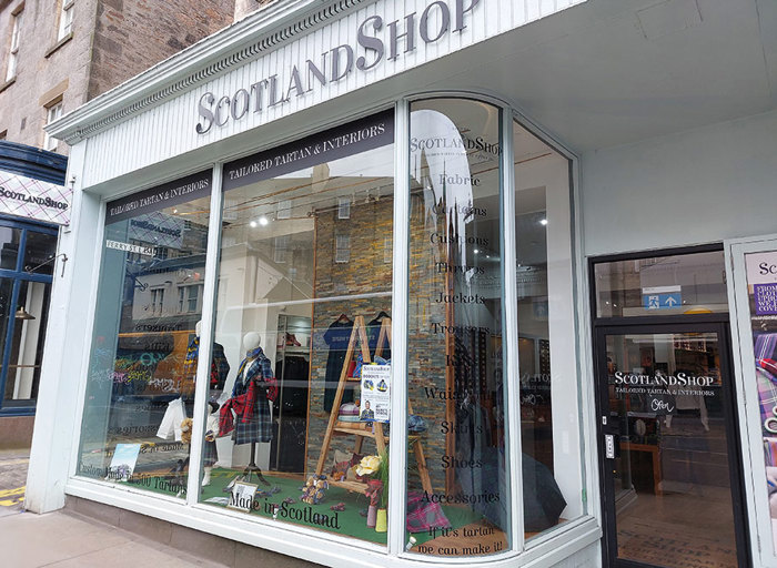 External shot of 'ScotlandShop' shop front in Edinburgh with various tartan products and Scottish items in the window