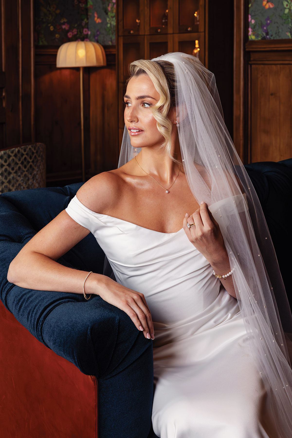 Bride wearing delicate diamond necklace, bracelet and pearl veil during luxury bridal jewellery photoshoot at Mar Hall