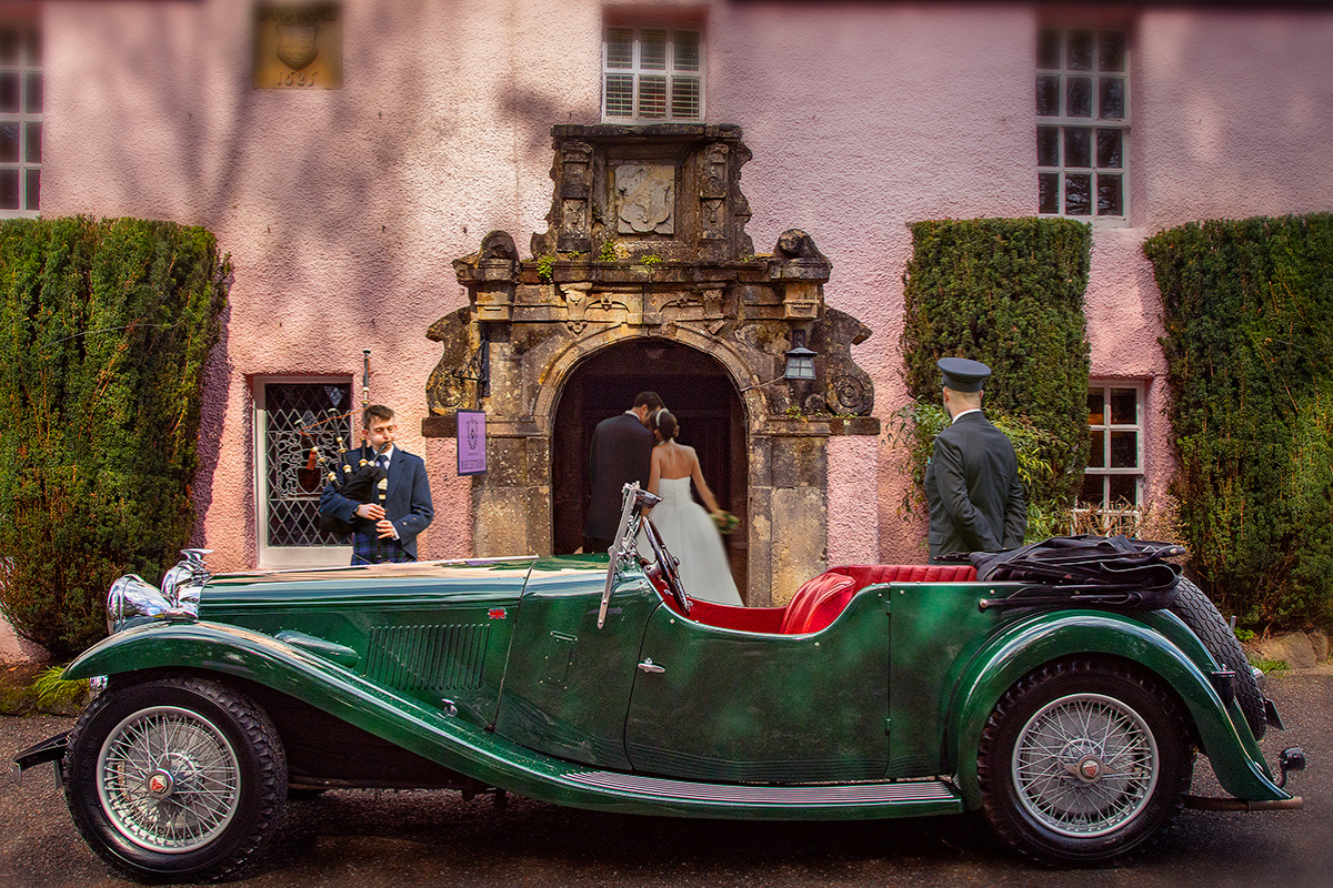 Vintage green wedding car outside the pink entrance of Thackray House in Callander as a couple enters the venue.