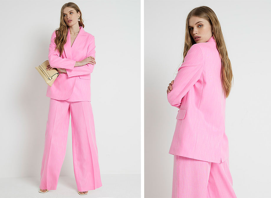 A woman wearing a pink suit