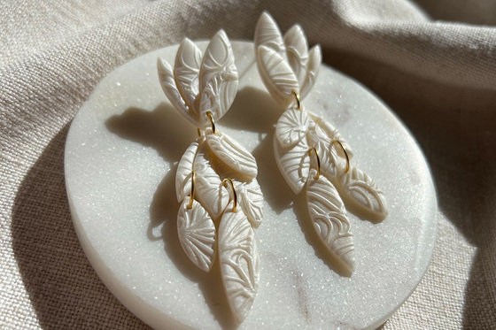 Pearlescent polymer clay leaf detail drop earrings with 18K gold plated hoops connecting each leaf