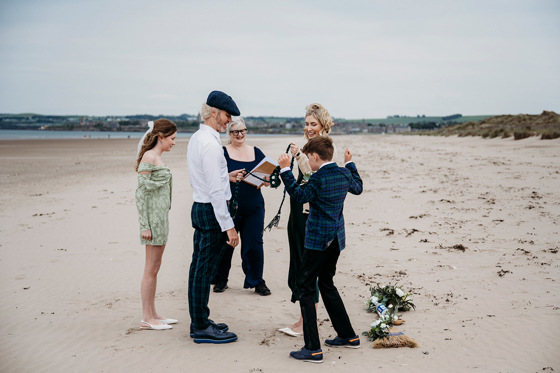 Relaxed Scottish beach wedding on West Sands, St Andrews, with a humanist celebrant leading a family-inclusive handfasting ceremony by the sea.
