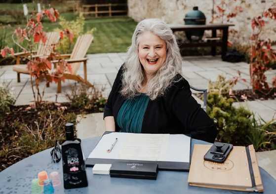 Yvonne Hannah, a humanist celebrant with Fuze Ceremonies, sits at a table on Penicuik Estate.