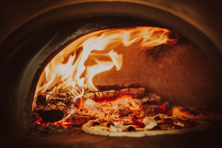 Pizza cooking in Dough Man's Land high-temperature pizza oven