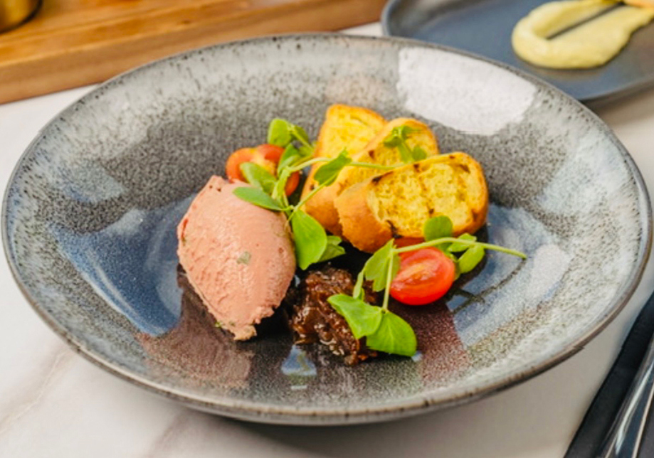 Plated wedding starter with pâté, chutney, toasted bread and fresh garnish