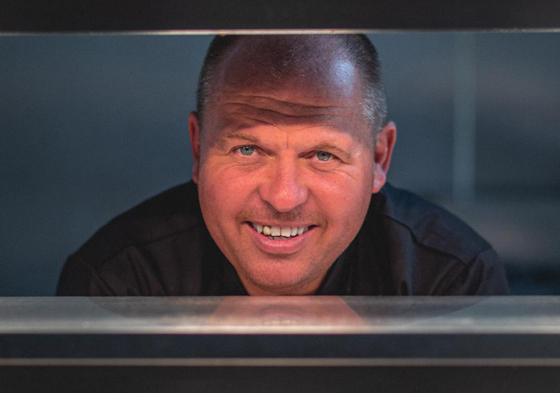 Food Creations wedding catering chef smiling in a professional kitchen