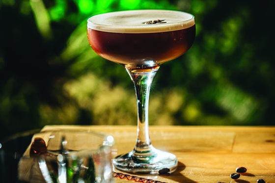 Image of an espresso martini with two coffee beans on foam