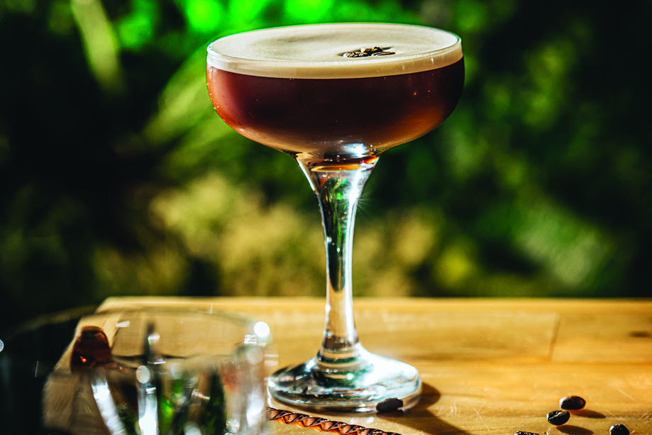 Image of an espresso martini with two coffee beans on foam