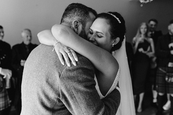 Bride hugs groom at the altar