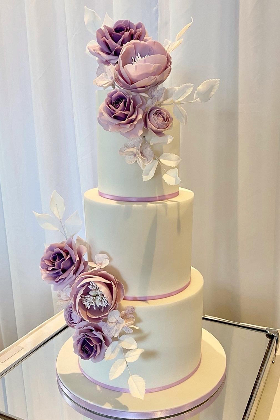 Mauve and cream three-tier cake with mauve roses 