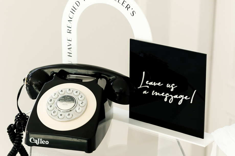 Black Calleo telephone with sign that reads "Leave us a message!"