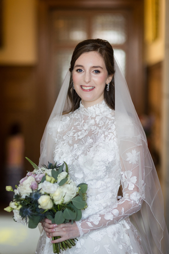 Bride with natural and glowy makeup smiles before ceremony