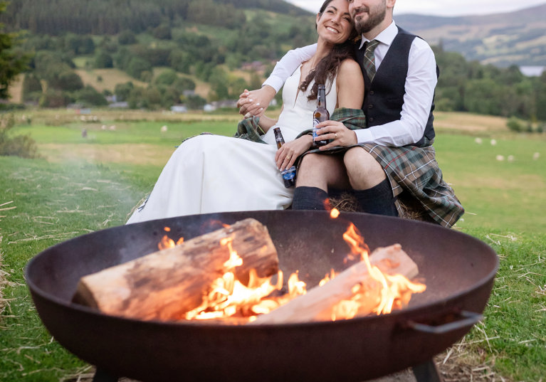 LochTay Wedding with Bride and Groom sitting at Fire Pit.