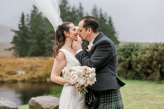 Bride and groom wedding portrait at Glencoe with a flowing veil and dramatic Scottish scenery