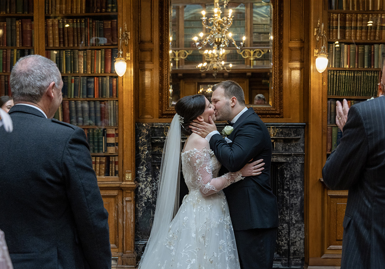 Bride and groom kiss at the altar